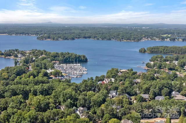 a view of a lake with lawn chairs