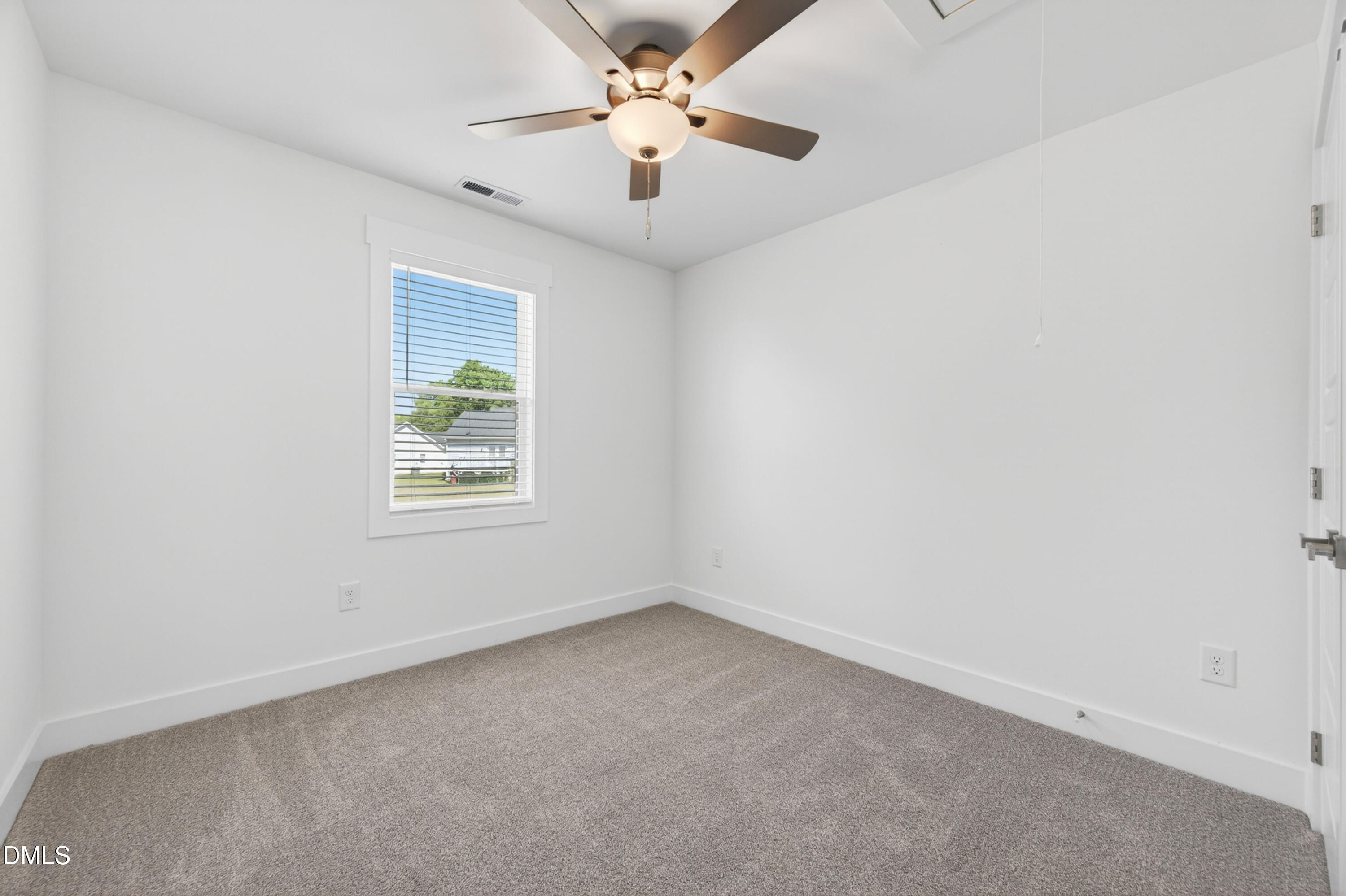 1256 Hurdle Mills Road Roxboro, NC 27573 - Photo 31 of 48 an empty room with a window and a ceiling fan