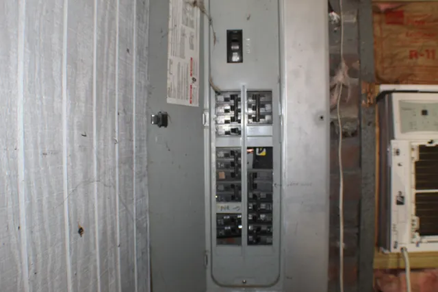 a dining room with furniture and a lamp
