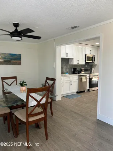 a kitchen with stainless steel appliances kitchen island granite countertop a sink and a stove