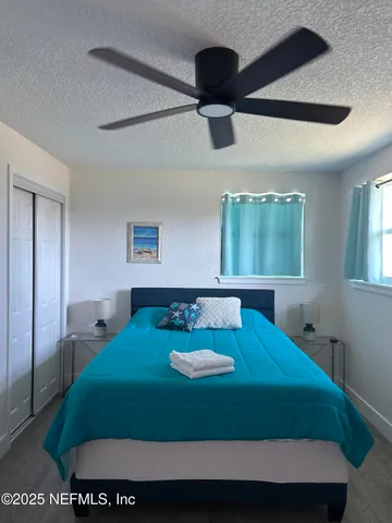 a bed sitting in a bedroom next to a window