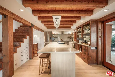 a living room with furniture and a painting on the wall