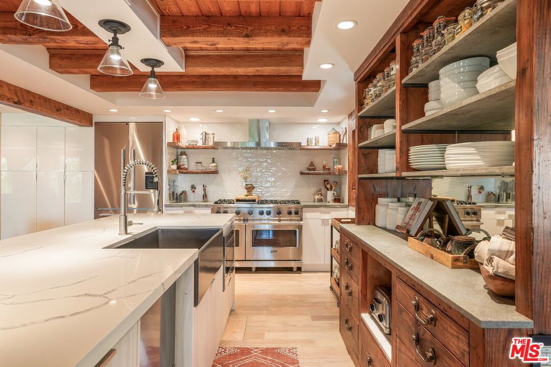 7336 Studio Road West Hills, CA 91304 - Photo 13 of 56 a kitchen with stainless steel appliances granite countertop a sink and a stove