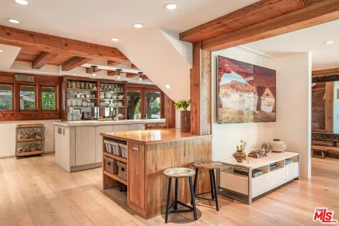 a spacious bedroom with a large bed and a wooden floor