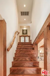 a view of a balcony with wooden floor and fence