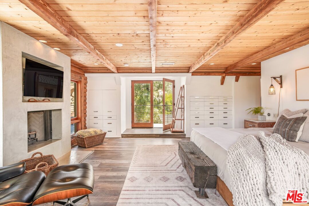 7336 Studio Road West Hills, CA 91304 - Photo 18 of 56 a spacious bedroom with a bed a flat screen tv and balcony view