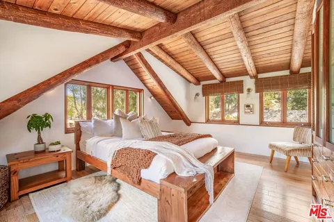 a view of a room with wooden floor and furniture