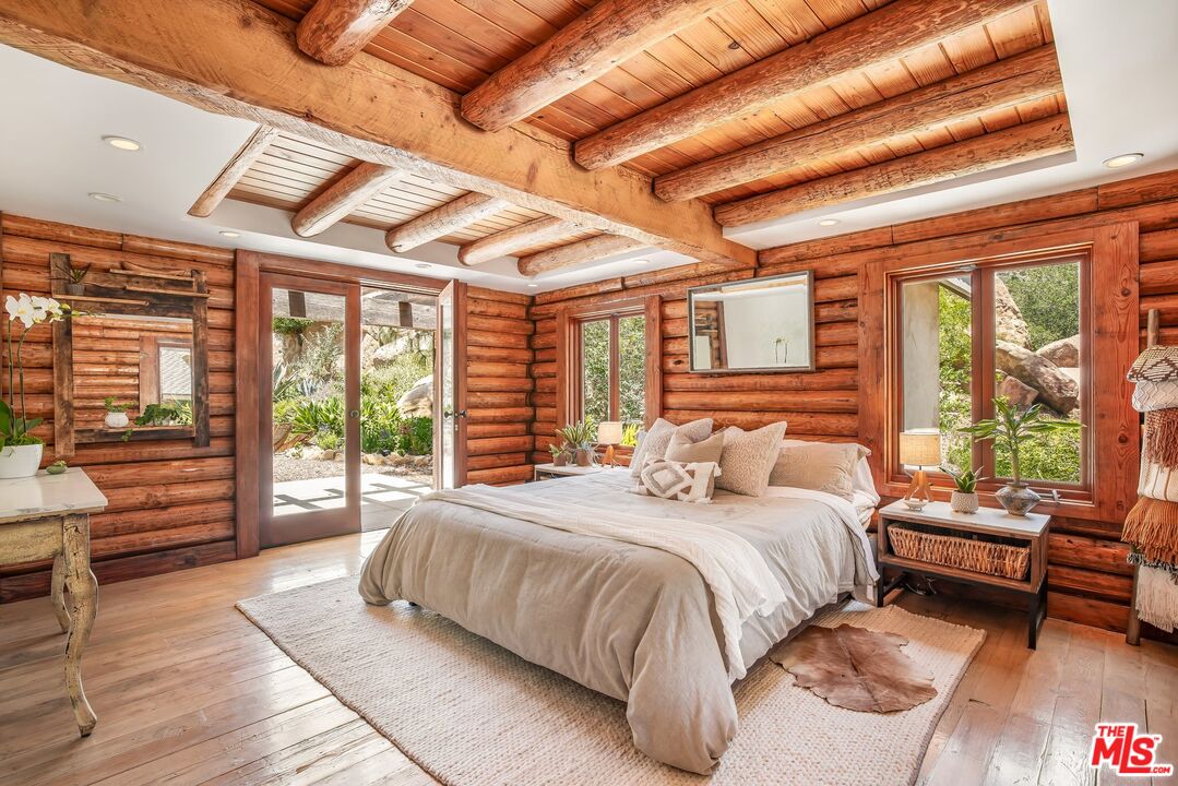 7336 Studio Road West Hills, CA 91304 - Photo 23 of 56 a bedroom with a large bed couch and a large window with outer view