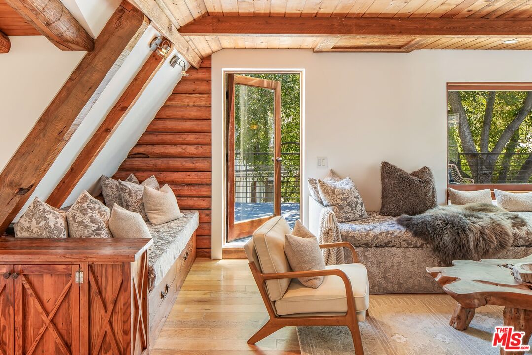 7336 Studio Road West Hills, CA 91304 - Photo 28 of 56 a living room with furniture and a floor to ceiling window