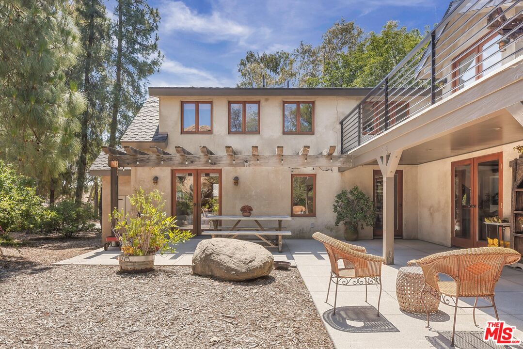 7336 Studio Road West Hills, CA 91304 - Photo 32 of 56 a view of a patio with couches table and chairs and potted plants