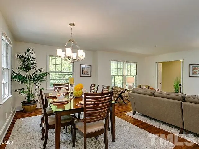 a living room with furniture a chandelier and a window