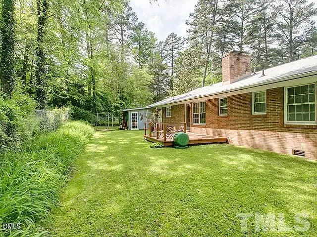 a view of a house with a backyard
