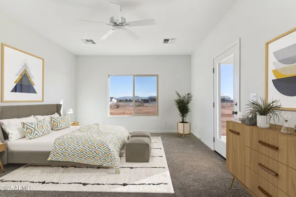 a bedroom with a large bed and a window