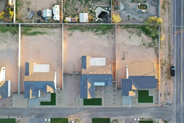 an aerial view of residential houses with outdoor space