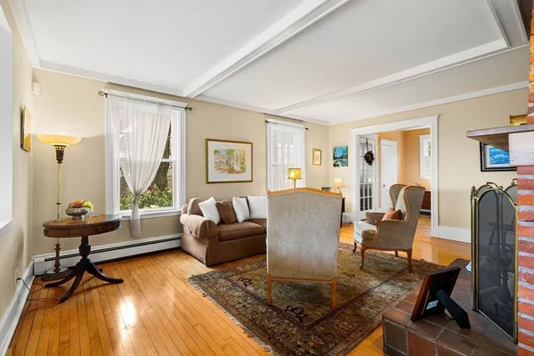 a living room with a bed furniture and a large window