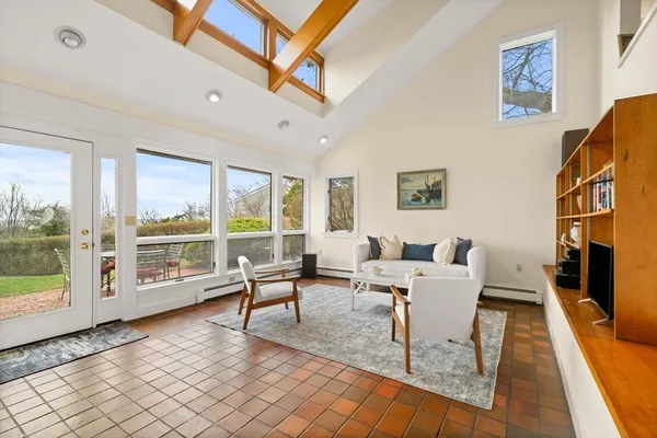 a bedroom with a bed and a large window