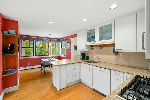 a kitchen with a sink stove and cabinets