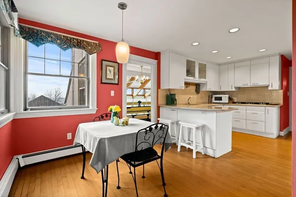 a kitchen with stainless steel appliances granite countertop a kitchen island a stove a table and chairs
