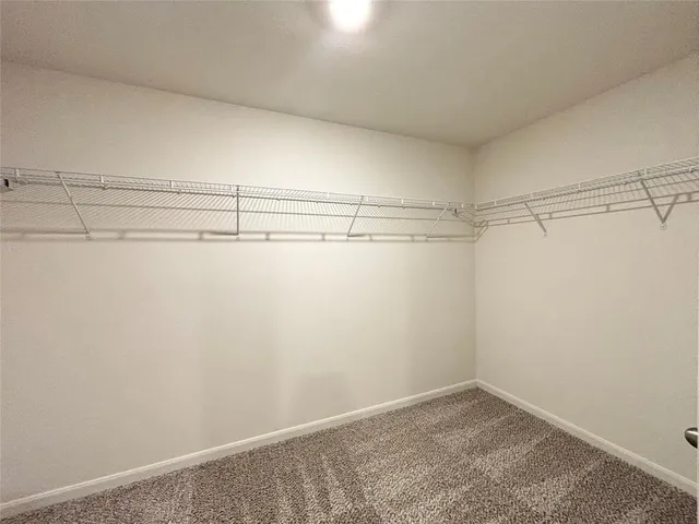 a view of a kitchen and a sink cabinet in an empty room
