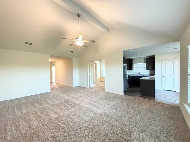 a kitchen with a refrigerator a microwave and sink