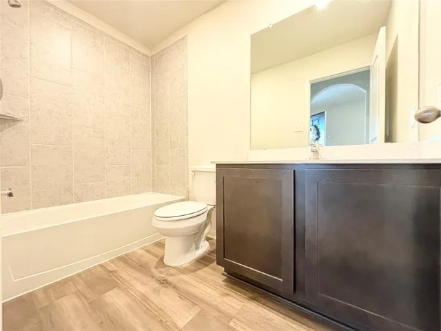 a bathroom with a toilet a sink and bathtub
