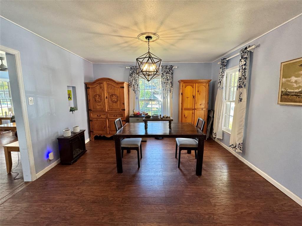 724 South Rusk Street Gainesville, TX 76240 - Photo 11 of 29 a living room with fireplace furniture and a wooden floor