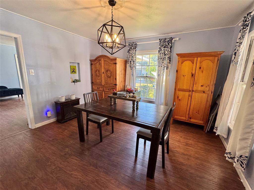 724 South Rusk Street Gainesville, TX 76240 - Photo 12 of 29 a view of a livingroom with furniture window and wooden floor