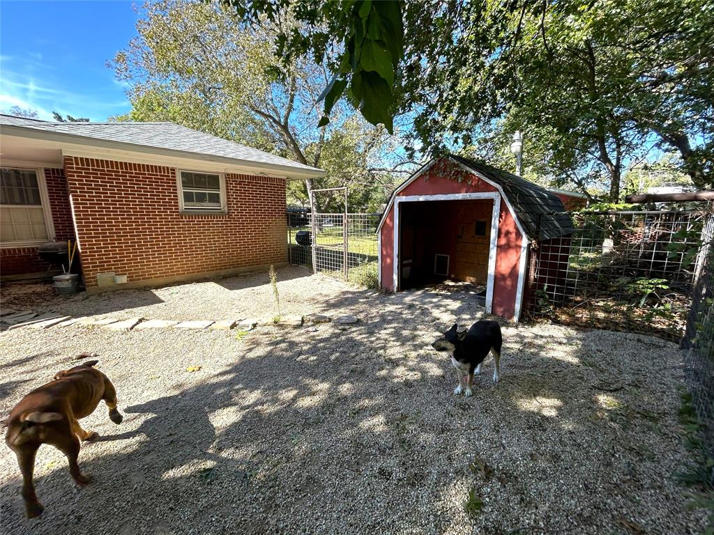 724 South Rusk Street Gainesville, TX 76240 - Photo 23 of 29 a backyard of a house with wooden fence and a tree