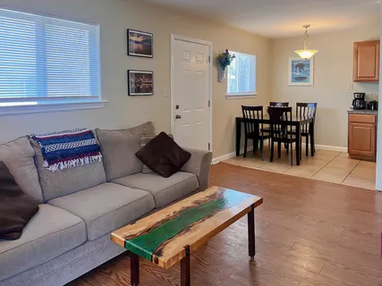 a living room with furniture and a dining table