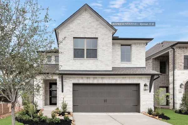 a front view of a house with garage
