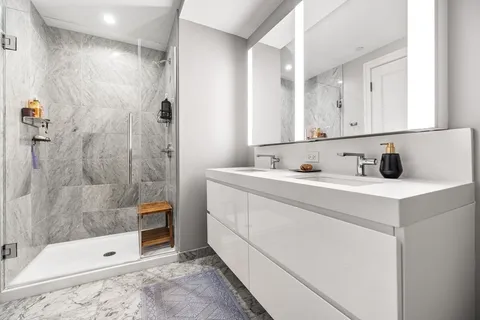 a bathroom with a tub sink and mirror