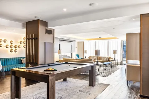 a large kitchen with stainless steel appliances granite countertop a large window and a sink