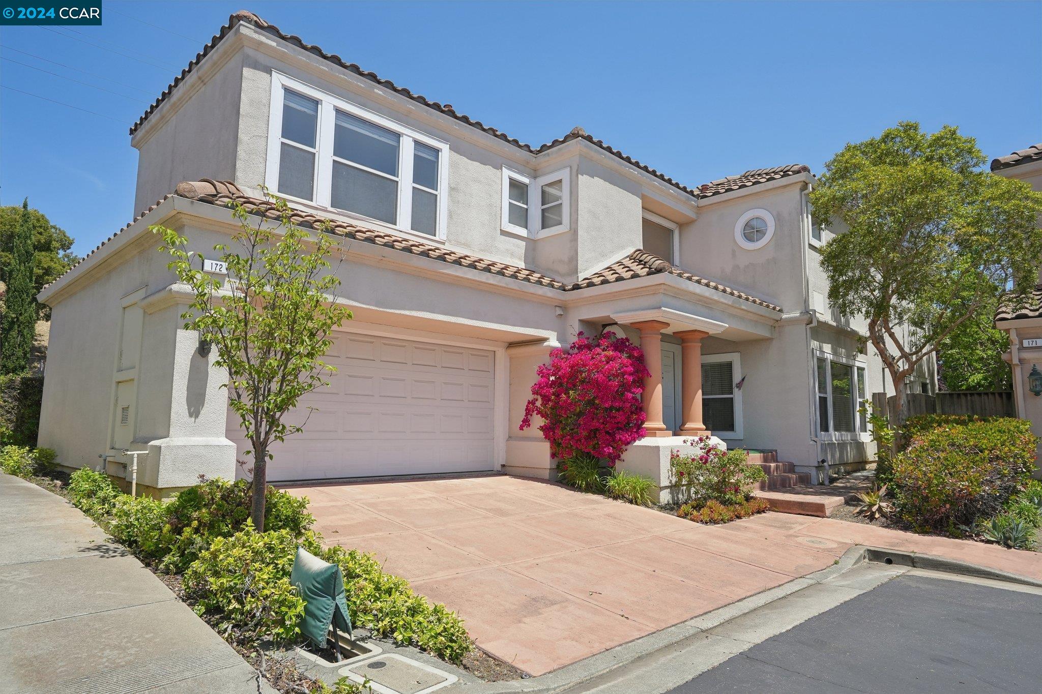 a front view of a house with a yard and garage