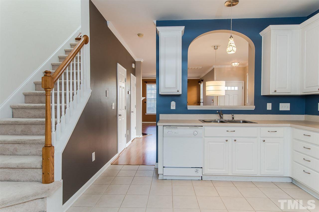 8312 City Loft Court Raleigh, NC 27613 - Photo 12 of 23 a view of a hallway with entryway sink and mirror