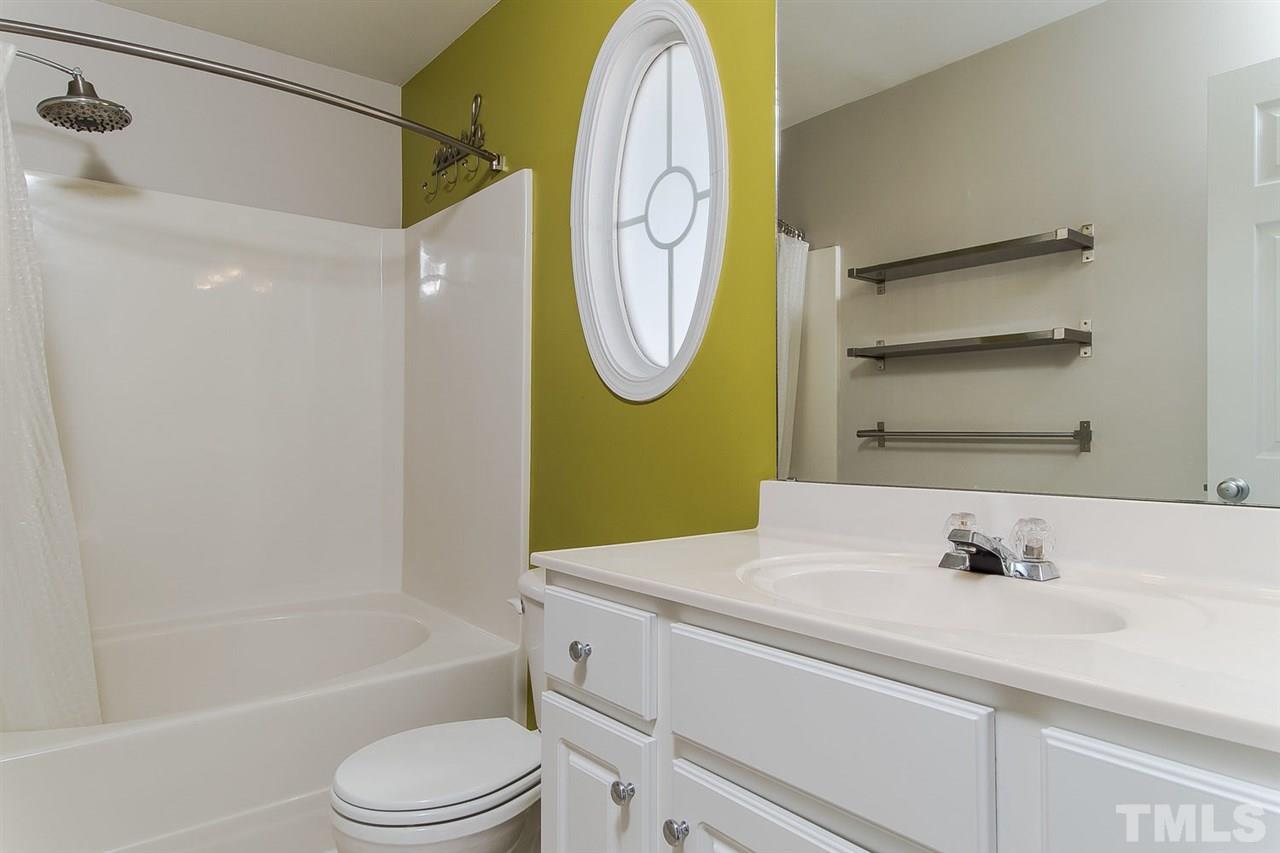 8312 City Loft Court Raleigh, NC 27613 - Photo 15 of 23 a bathroom with a sink a toilet and a bathtub