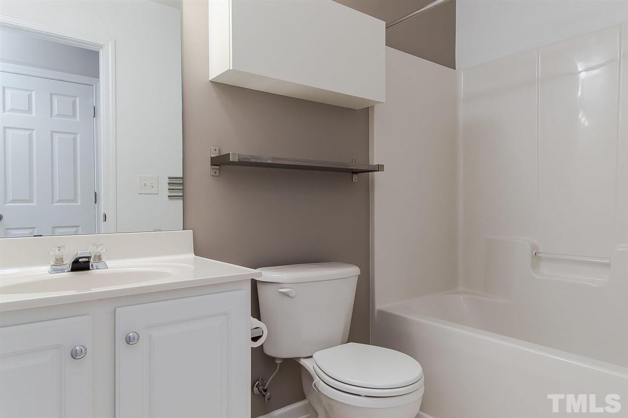 8312 City Loft Court Raleigh, NC 27613 - Photo 17 of 23 a bathroom with a sink a toilet and bathtub