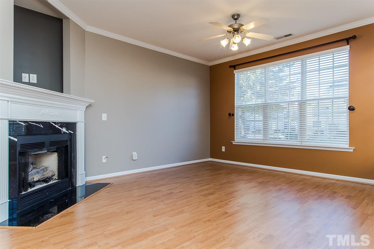 8312 City Loft Court Raleigh, NC 27613 - Photo 5 of 23 a view of an empty room with a fireplace and a window