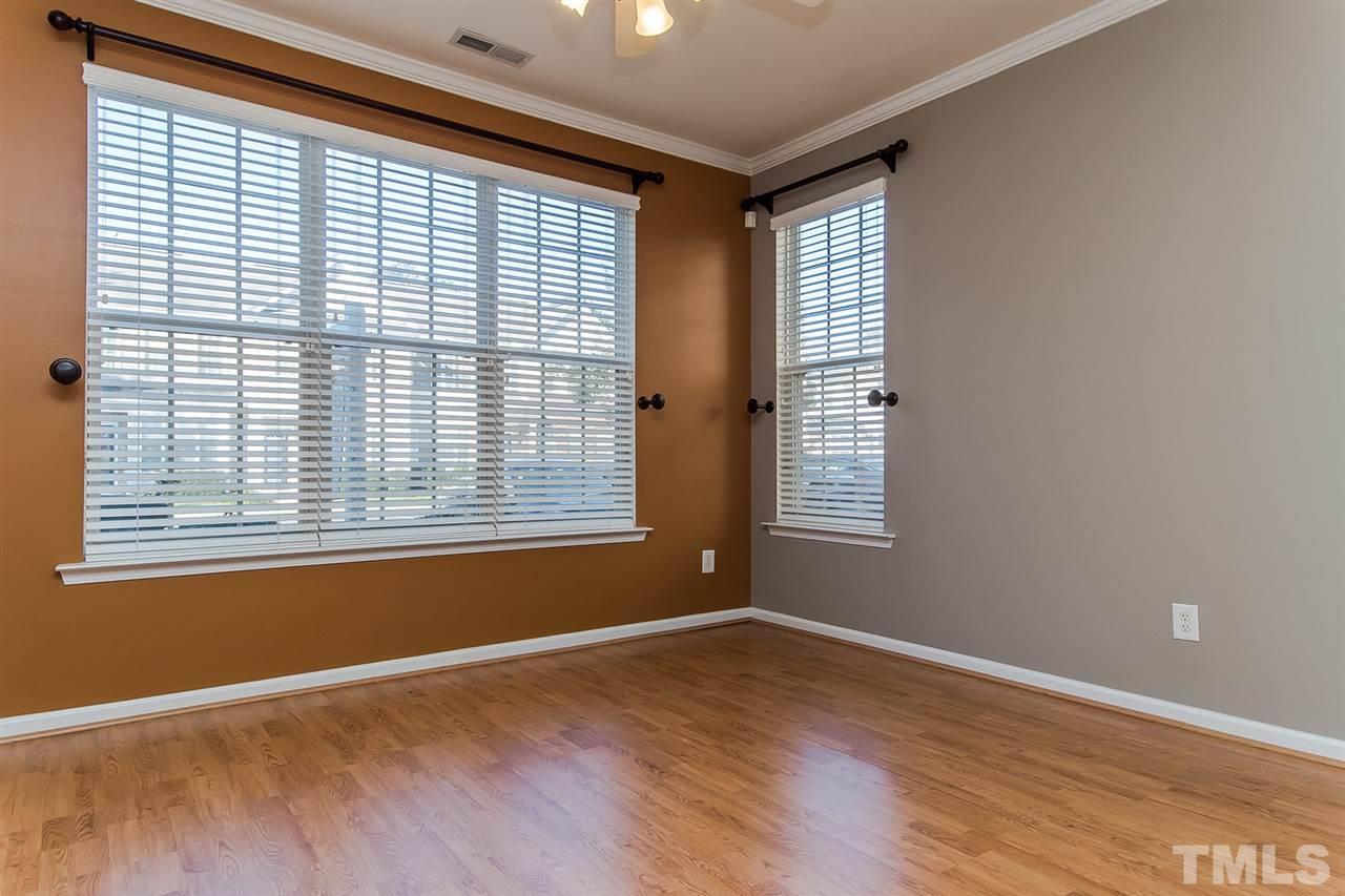 8312 City Loft Court Raleigh, NC 27613 - Photo 6 of 23 a view of empty room with wooden floor and fan
