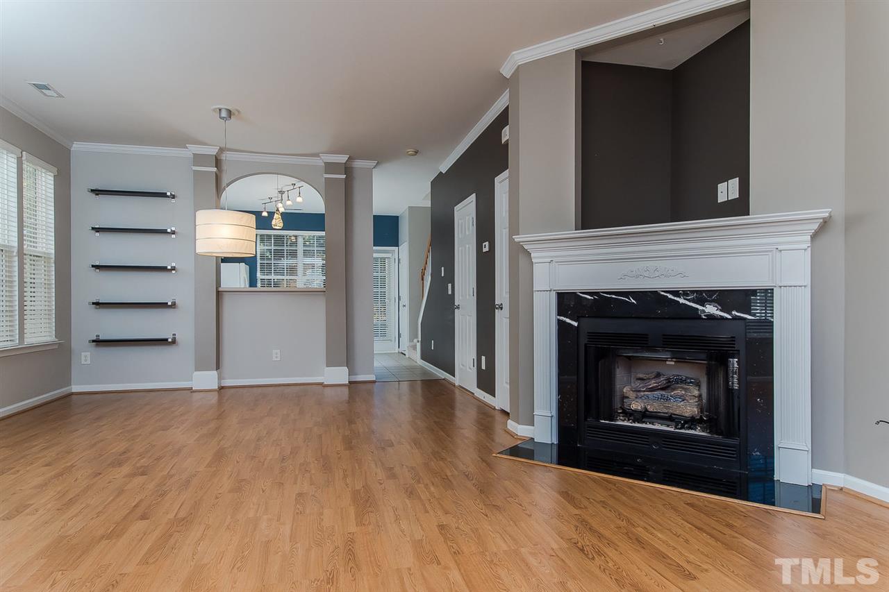 8312 City Loft Court Raleigh, NC 27613 - Photo 7 of 23 a view of an empty room with a fireplace and a window