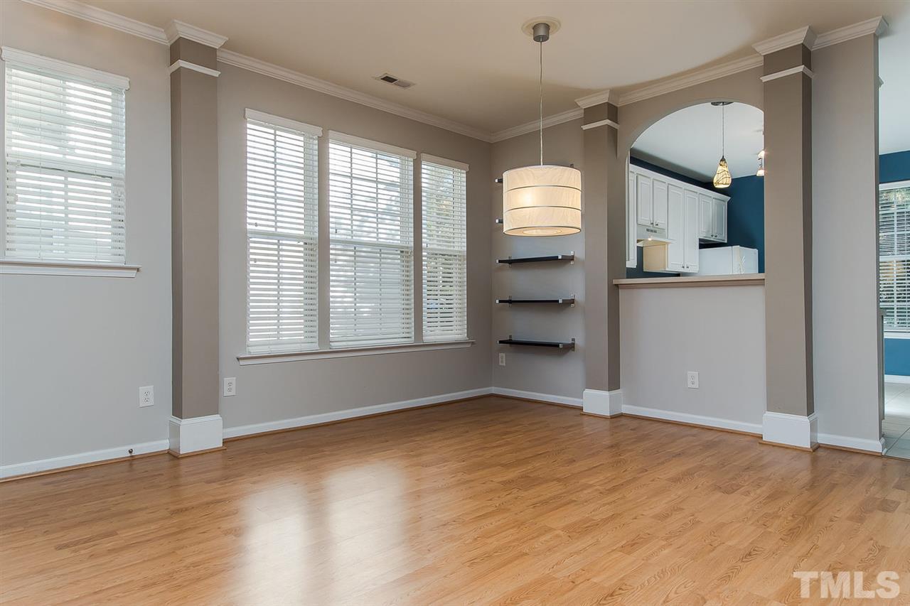 8312 City Loft Court Raleigh, NC 27613 - Photo 8 of 23 a view of an empty room with a window and wooden floor
