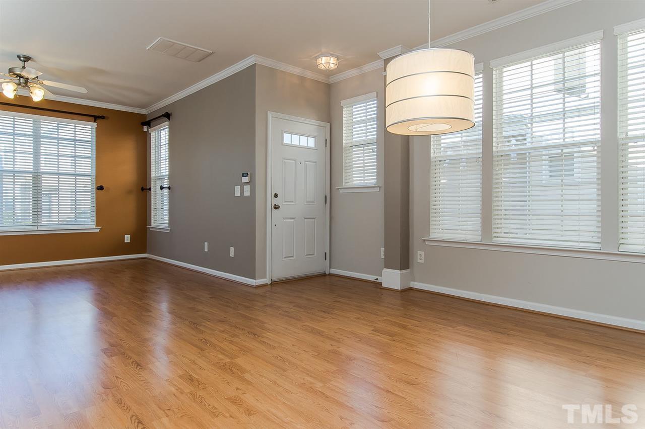 8312 City Loft Court Raleigh, NC 27613 - Photo 9 of 23 an empty room with wooden floor and windows