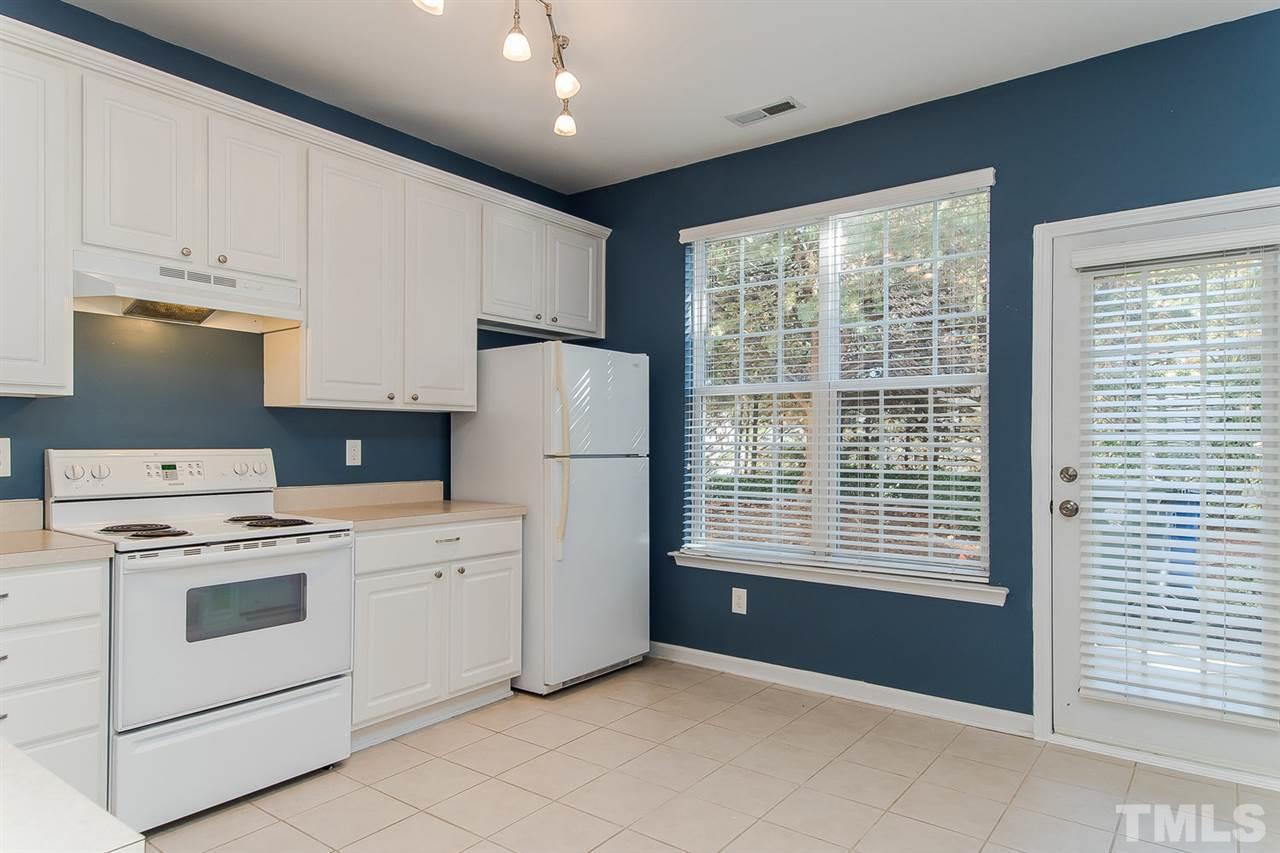 8312 City Loft Court Raleigh, NC 27613 - Photo 10 of 23 a open kitchen with white cabinets and white appliances