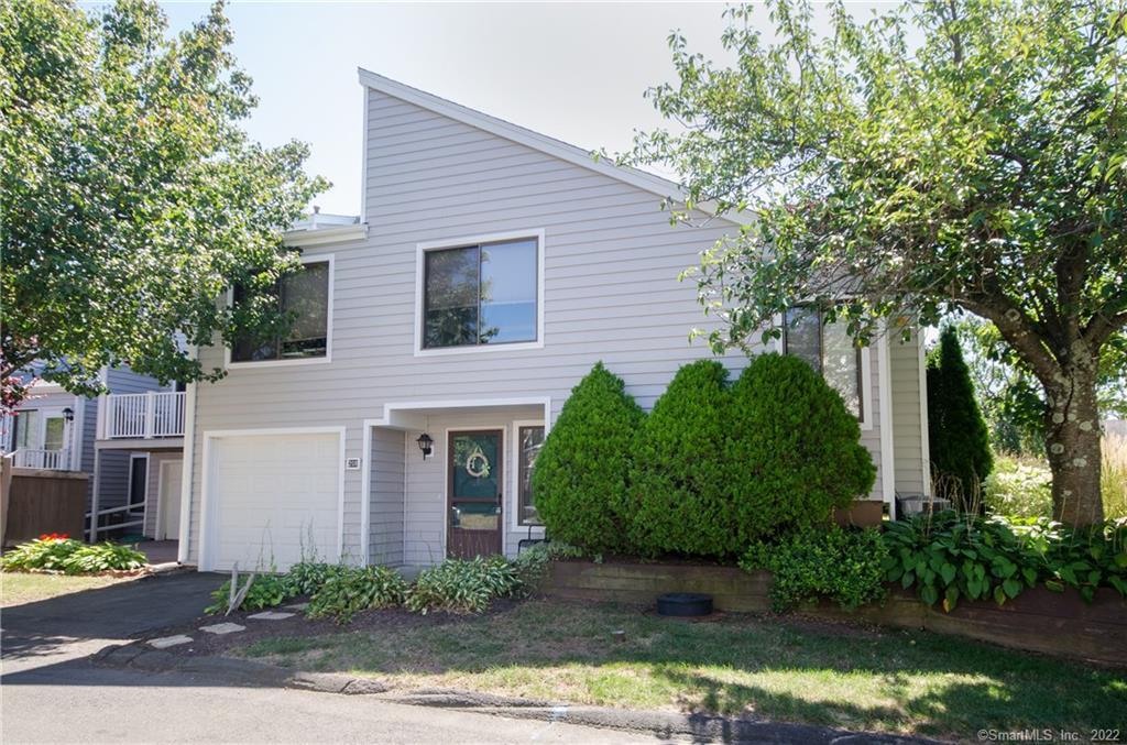 208 Crosswoods Road, Unit 208 Branford, CT 06405 - Photo 1 of 1 a front view of a house with garden