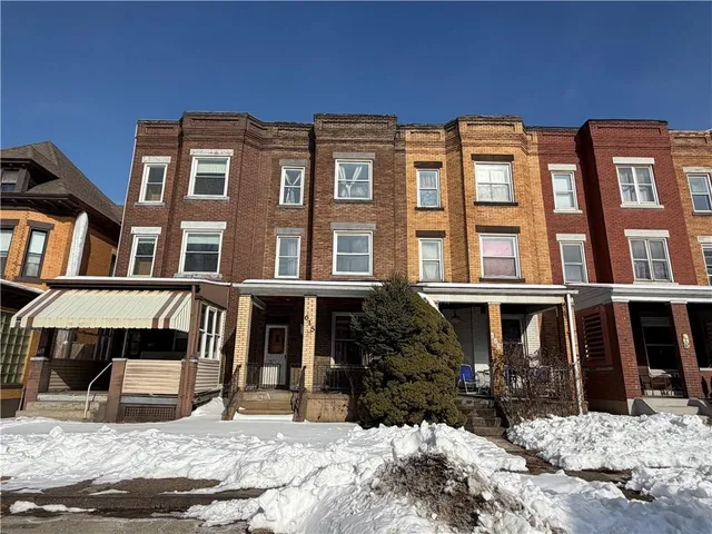 a front view of a building with a yard