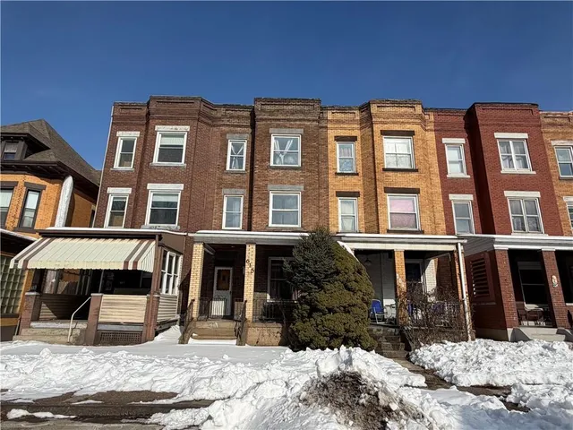 a front view of a building with a yard