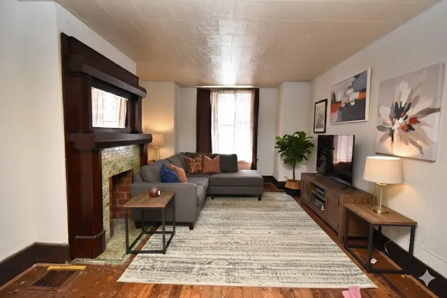 a living room with furniture and a fireplace