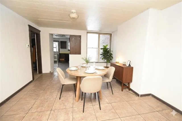 a view of a dining room with furniture and window