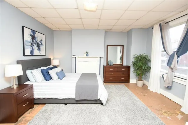 a bedroom with a large bed and a chandelier