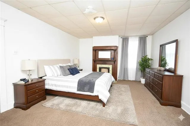 a bedroom with a large bed and wooden floor