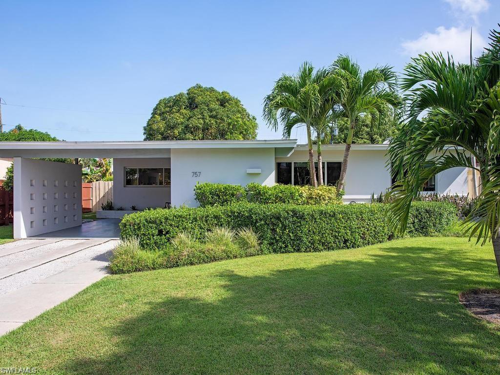 757 Broad Court South Naples, FL 34102 - Photo 1 of 12 a front view of a house with a garden